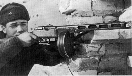 Russian soldier holding a PPSH during combat.