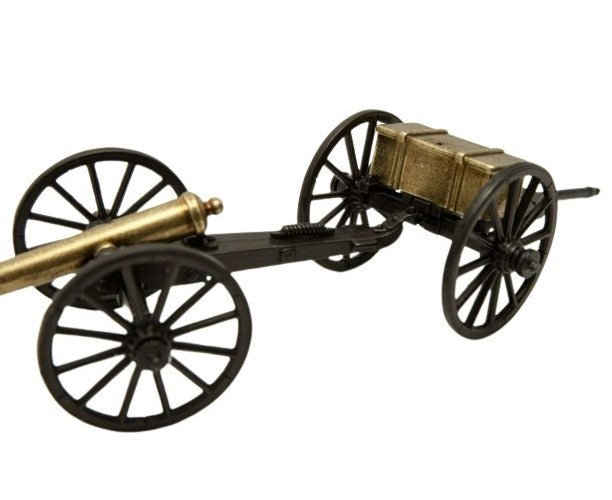 Model of a cannon with four wheels on a white background