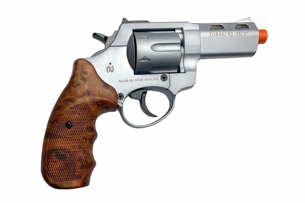 Revolver with wooden grip and silver metal on a white background
