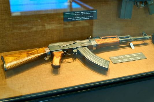 Soviet AK-47 rifle with traditional wooden stock and curved magazine displayed at Athens War Museum