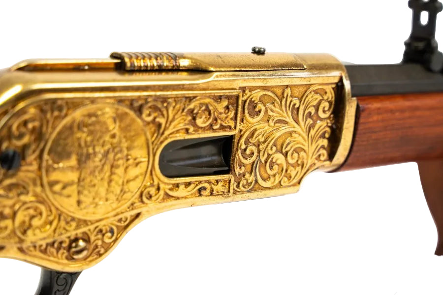 Model 1873 lever action rifle replica with engraved gold receiver and wood stock