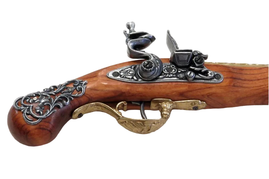 Close up of 18th century British flintlock pistol replica showing engraved brass frame and realistic details