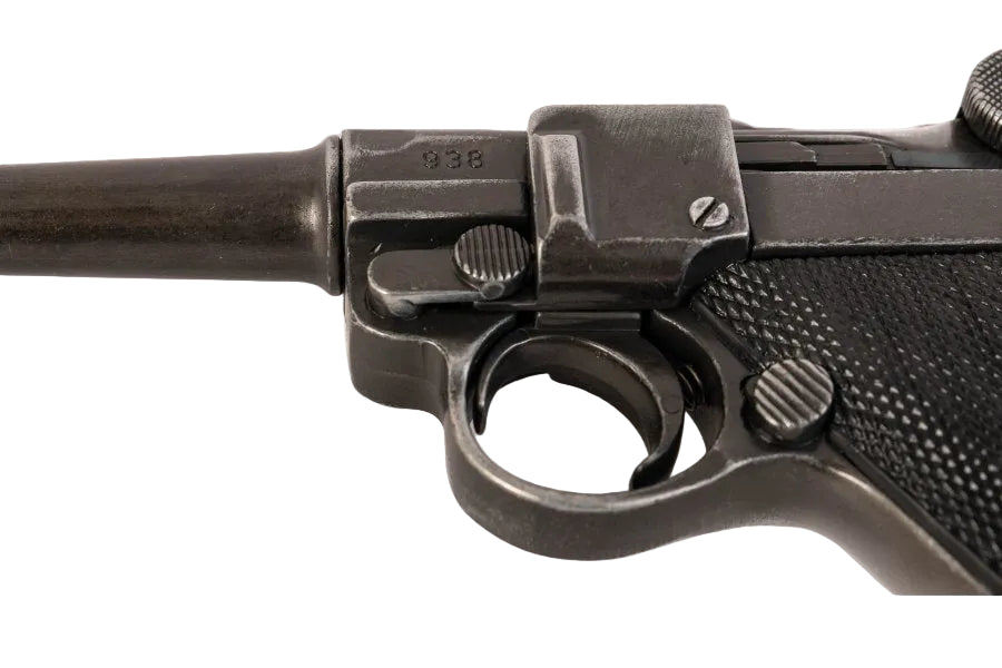 Close-up of a black firearm with 'Denix' branding on a white background