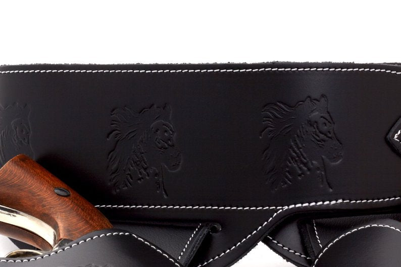 detailed view of the 2 horses stamped into the double rig leather holster
