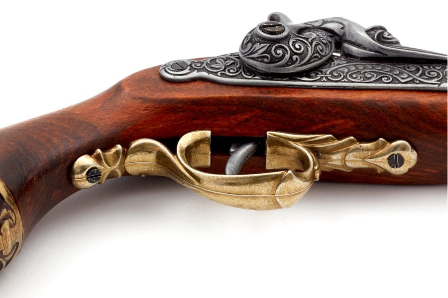 Antique style brass dueling pistol replica with detailed engravings