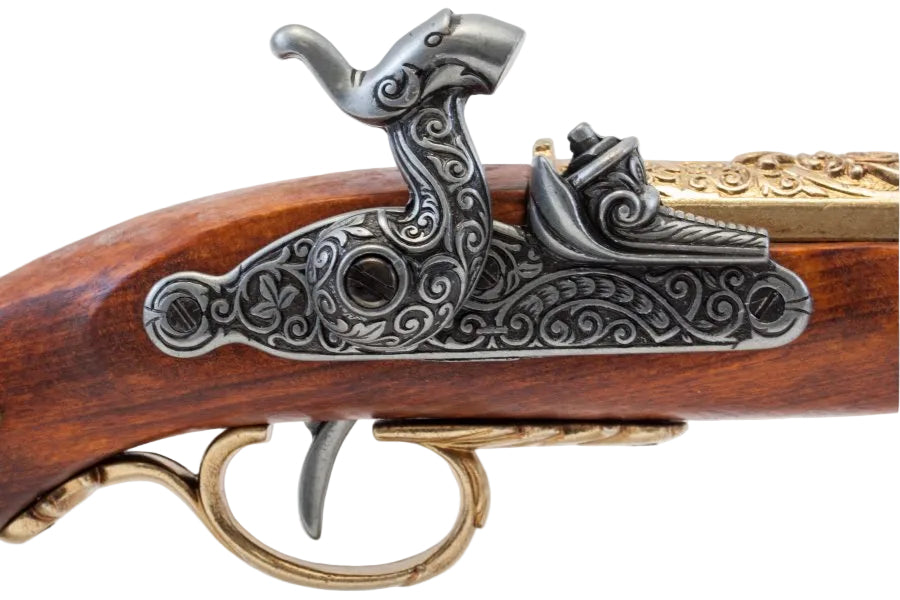 Close up of antique brass French percussion pistol replica showcasing authentic engravings and craftsmanship