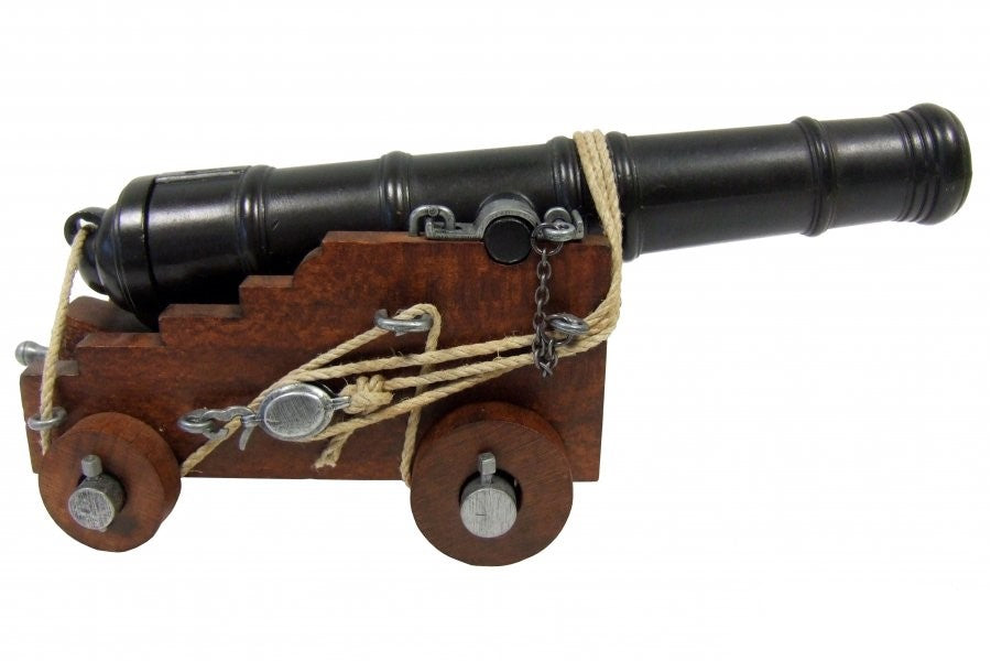 Model cannon on wheels with a wooden base and metal components on a white background