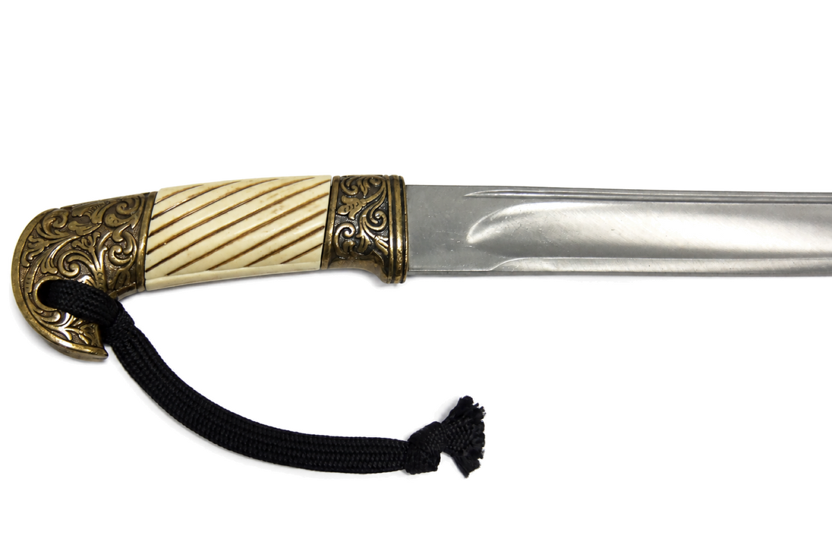 Close view of the faux-ivory grip and brass-tone hilt on the Denix 4135 Shashka sabre