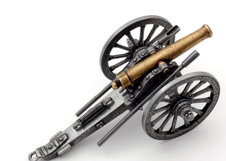 Model of a cannon on wheels with a white background