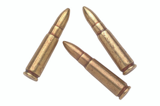 Three brass rifle cartridges on a white background