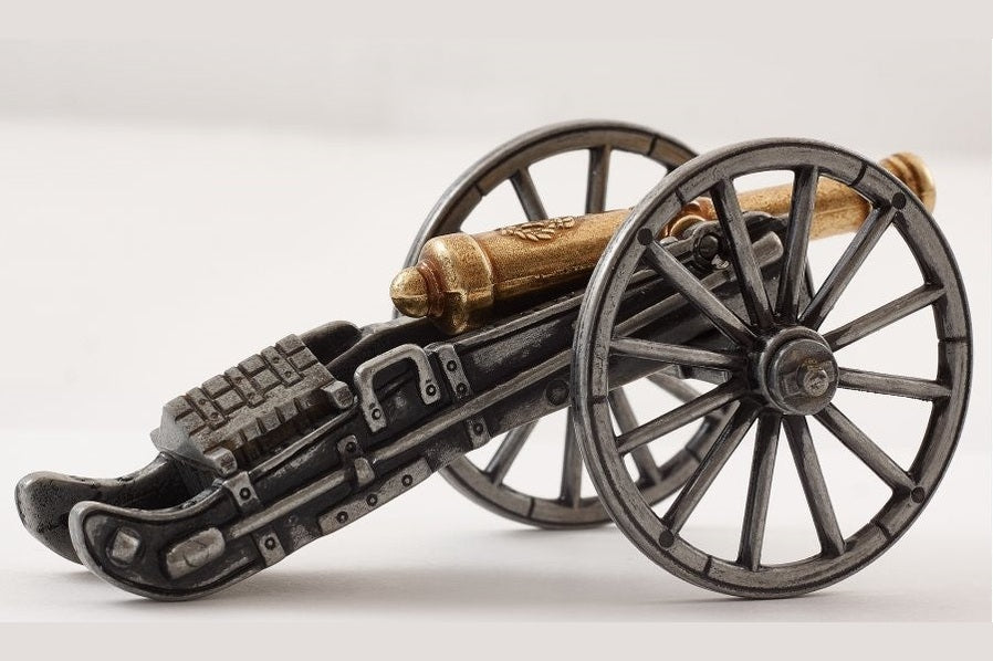 Model of a cannon on wheels with a white background