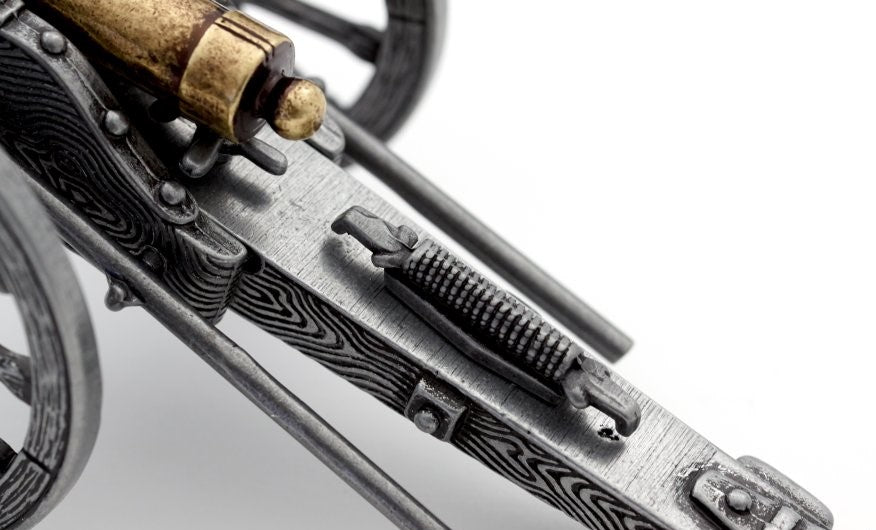 Close-up of a metallic object with intricate design on a white background