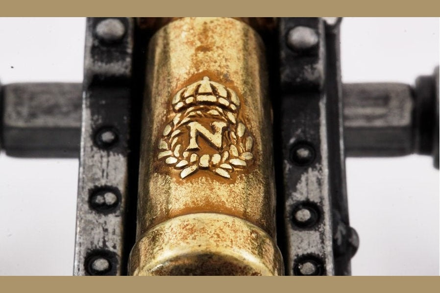 Close-up of a gold bolt with a logo on a metallic background