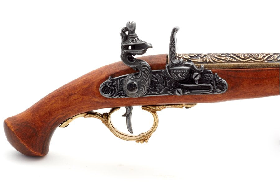 Close up of engraved flintlock mechanism on German replica pistol