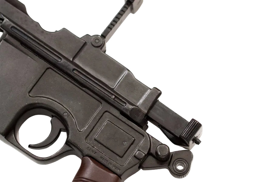 Close up of Denix Mauser C96 replica pistol showing detailed metal finish and wood style grips