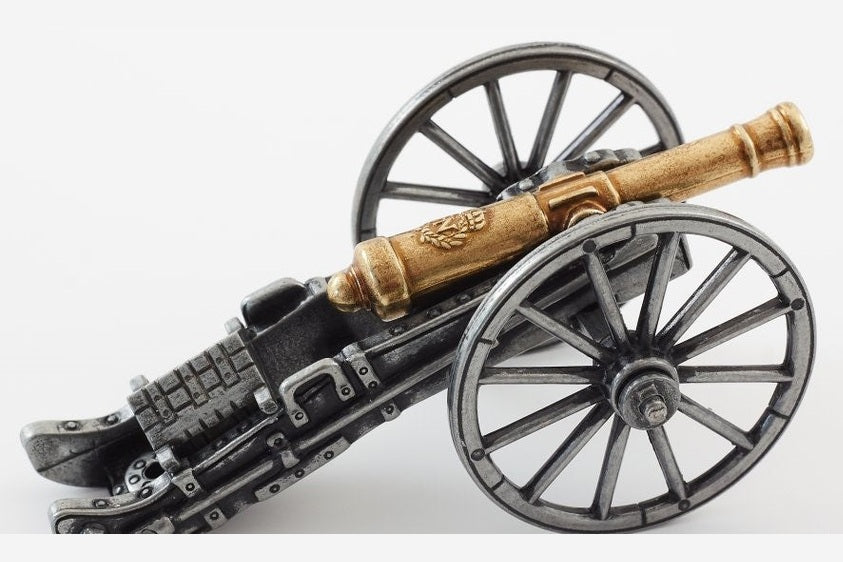 Model of a cannon with metallic body and wooden barrel on a white background