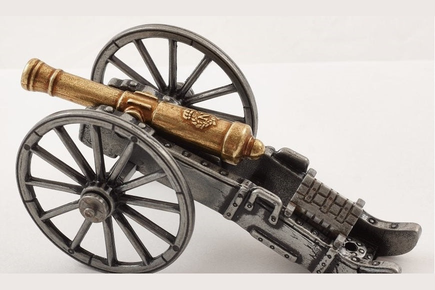 Model cannon with wheels on a white background