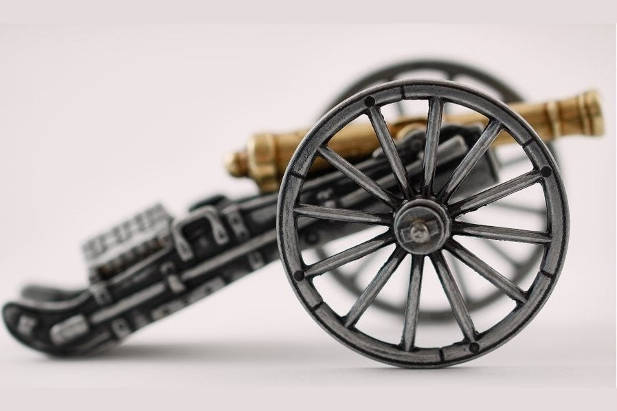Metallic toy cannon on a white background